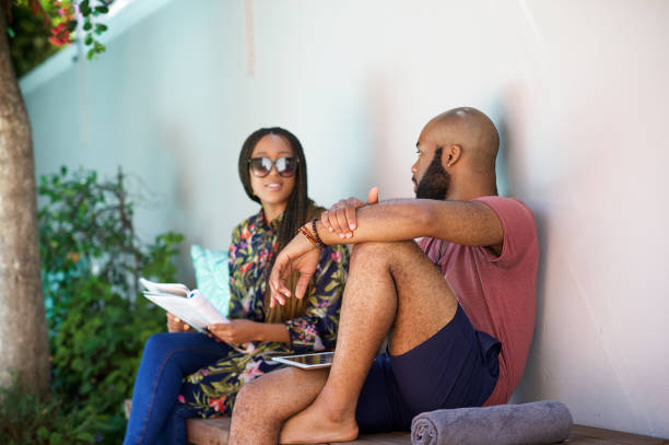 istock Couple Sitting relaxing on a bench chatting seriously 1205748325