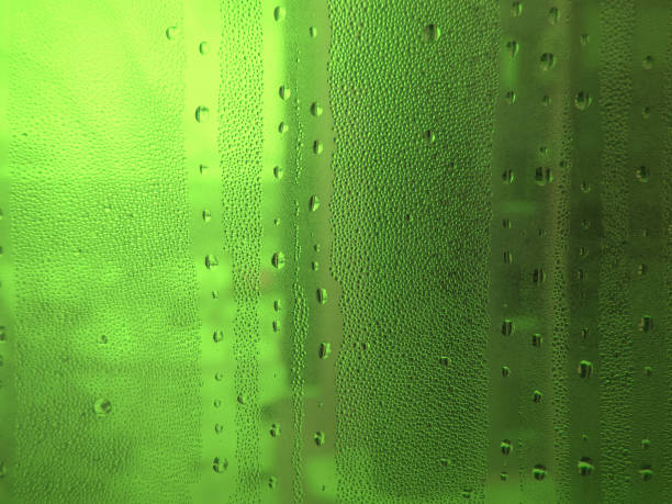 istock Green misted glass with drops of water 1205750606