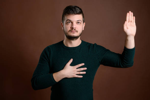 istock Man with brown hair showing oath 1205750669