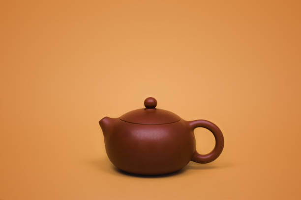 istock Yixing clay teapot, tea ceremony, on orange background 1205751929