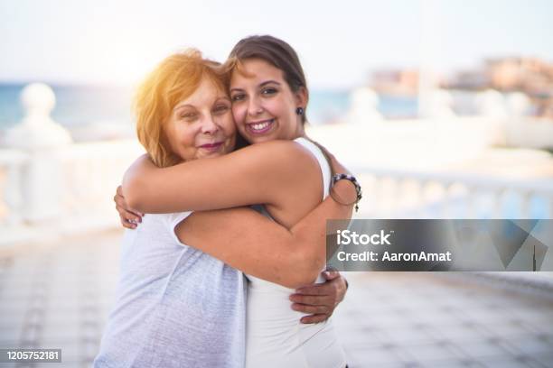 Beautiful Mother And Daugther Hugging At Terrace With Happy Face Stock Photo - Download Image Now