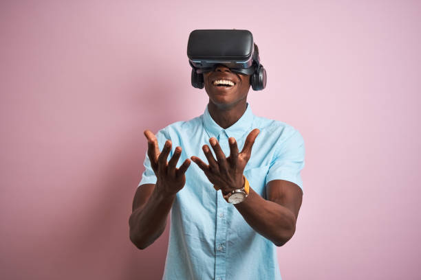 istock Young african american man playing virtual reality game using goggles 1205753277