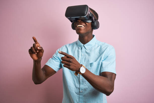 istock Young african american man playing virtual reality game using goggles 1205753279