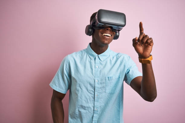 istock Young african american man playing virtual reality game using goggles 1205753283
