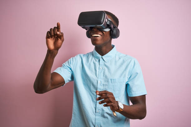istock Young african american man playing virtual reality game using goggles 1205753292