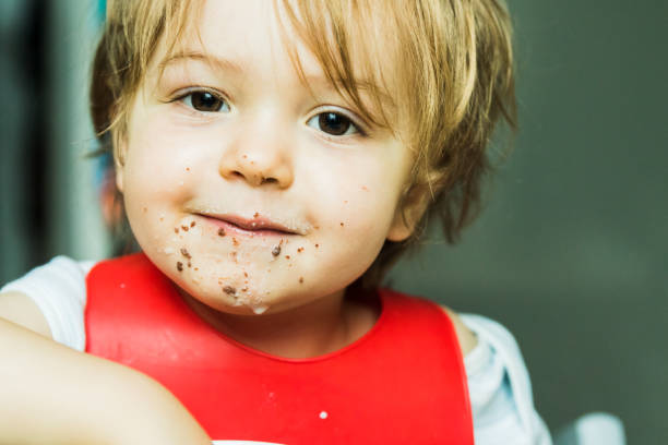 istock portrait adorable child eating chocolate sponge cake 1205756171