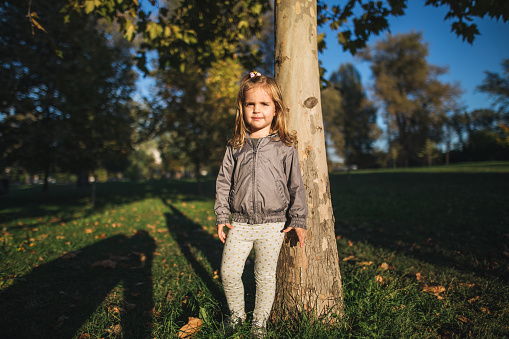 Cute little girl enjoying sunny day at public park