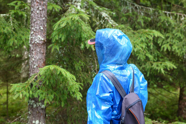 istock Woman in blue protective polyethylene raincoat agains 1205757351