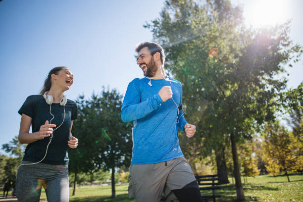 istock Carefree workout couple jogging on a sunny day 1205757626