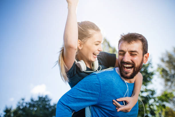 istock Cheerful playful couple having fun on a morning run 1205757684