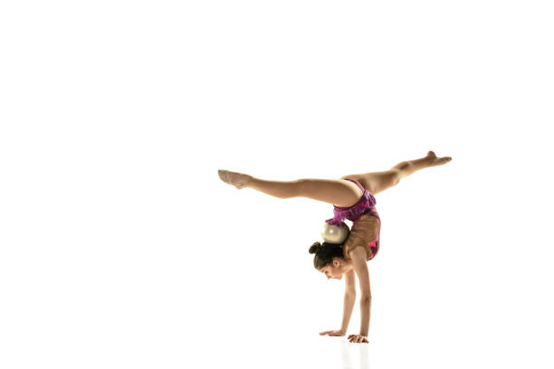 istock Young flexible female gymnast isolated on white studio background 1205758474