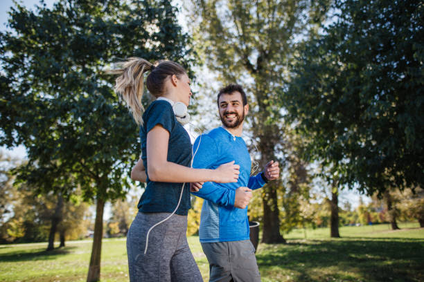 istock Handsome man flirting with a women on a morning run 1205758610