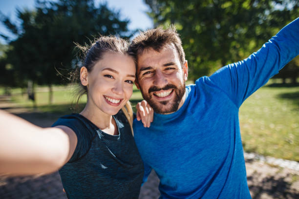 istock Excited workout couple taking selfie after morning jogging 1205760323