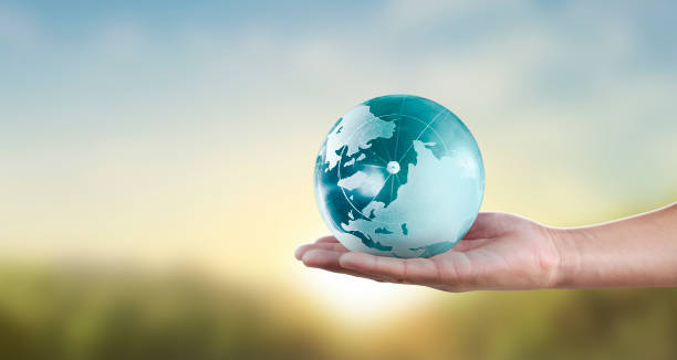 istock Globe ,earth in human hand, holding our planet glowing 1205760435