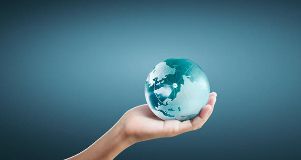 istock Globe ,earth in human hand, holding our planet glowing 1205760437