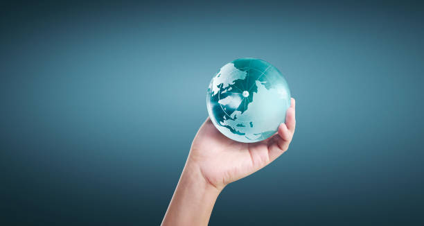 istock Globe ,earth in human hand, holding our planet glowing 1205760439