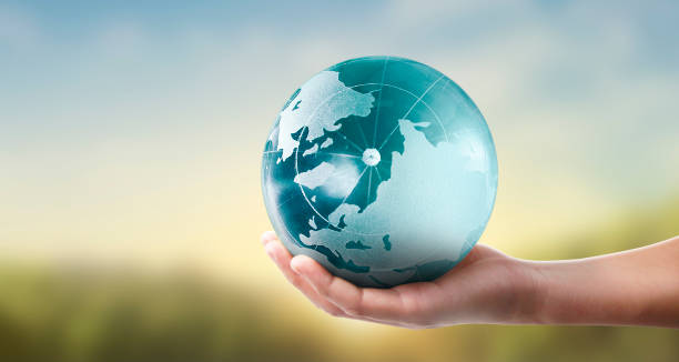 istock Globe ,earth in human hand, holding our planet glowing 1205760441