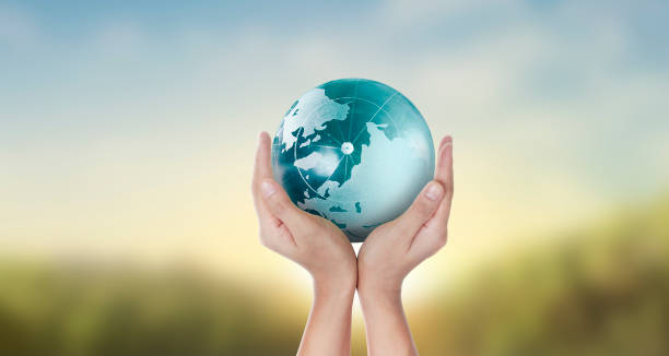 istock Globe ,earth in human hand, holding our planet glowing 1205760442