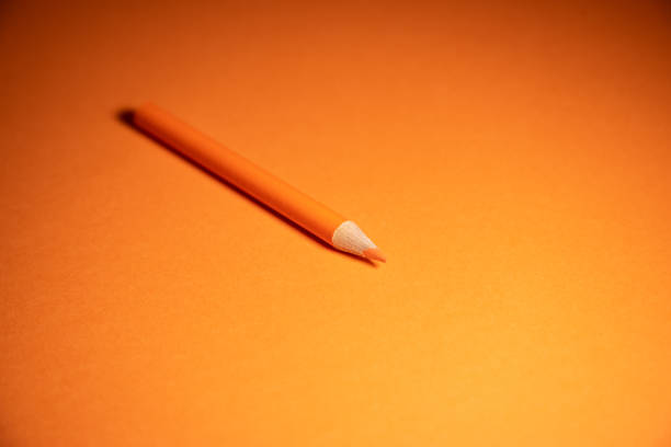 istock orange color pencil and background 1205760767
