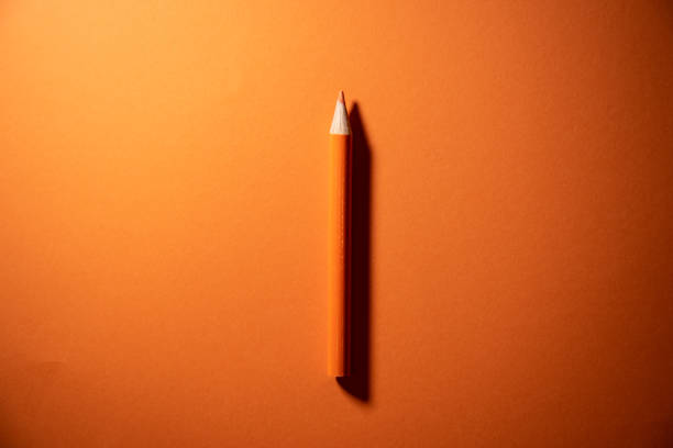 istock orange color pencil and background 1205760782