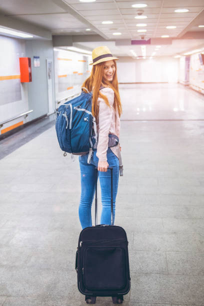 istock Young woman goes on a journey with a suitcase 1205761012