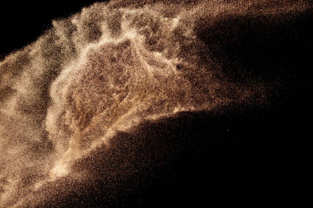 istock Brown colored sand splash.Dry river sand explosion isolated on black background. Abstract sand cloud. 1205761033