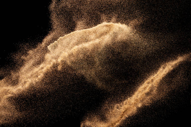 istock Brown colored sand splash.Dry river sand explosion isolated on black background. Abstract sand cloud. 1205761042