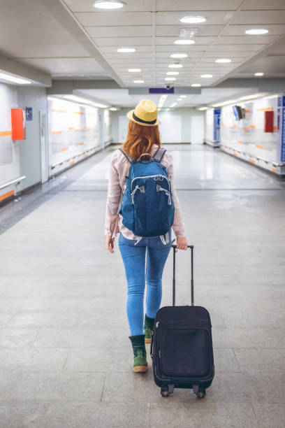 istock Young woman goes on a journey with a suitcase 1205761061
