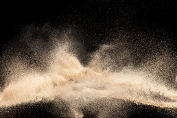 istock Brown colored sand splash.Dry river sand explosion isolated on black background. Abstract sand cloud. 1205761108