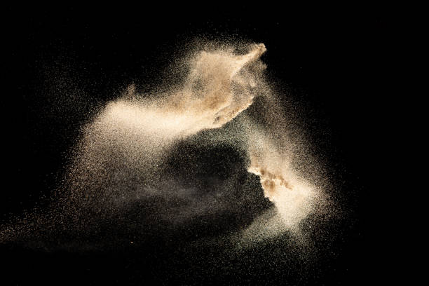 istock Brown colored sand splash.Dry river sand explosion isolated on black background. Abstract sand cloud. 1205761114