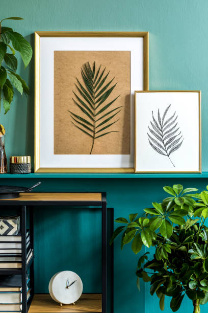 istock Modern composition of mock up photos frames, stylish shelf with personal accessoreis, books, decoration, clock and plants. Green wood panelling. Deisgn home staging of living room. Template. 1205763959