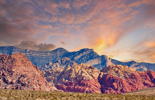 istock Red Rock and Blue Mountains Rising from Desert at Sunset 1205764075