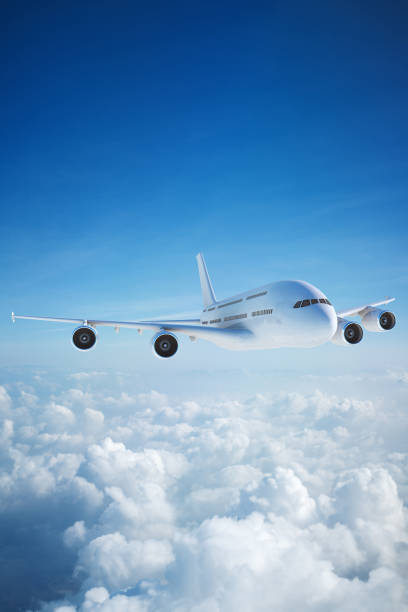 istock White passenger aircraft flying over clouds 1205764322