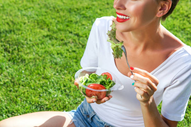 istock Beautiful caucasian woman eating salad 1205765849