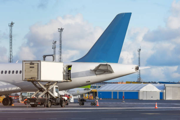Airplane tail view- service before flights, service machine for loading. Airplane tail view- service before flights, service machine for loading airplane food stock pictures, royalty-free photos & images