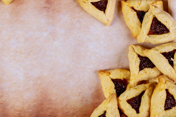 istock Purim background with cookies on parchment paper. 1205767905