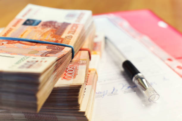 istock Money stacks - one and a half million russian rubles and signed contract 1205768114