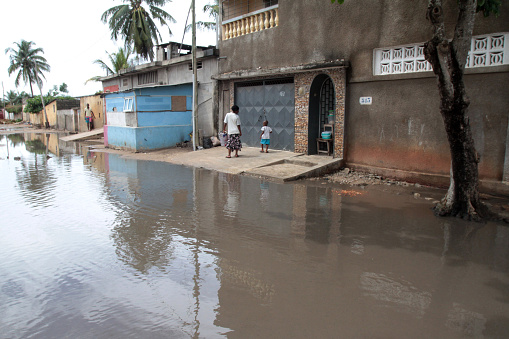 West Africa. Togo. Lome. 10/25/2011. This colorful image depicts a flood and the flow of rainwater in the roads of a poor neighborhood and an area of housing.