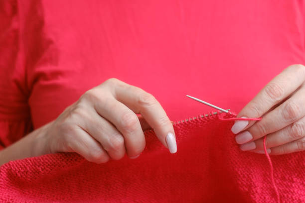 istock knitting a warm sweater and red wool yarn 1205768541