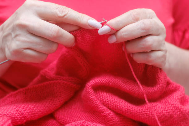 istock knitting a warm sweater and red wool yarn 1205768605