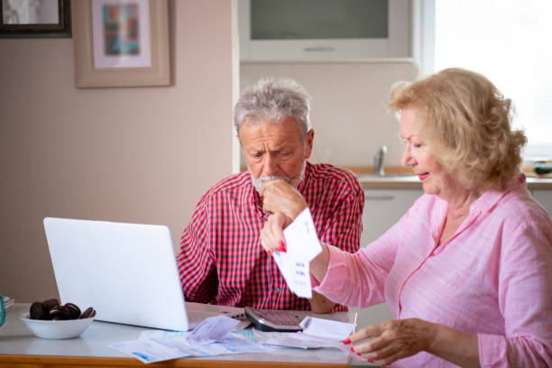 istock Serious mature couple calculating bills to pay 1205769532