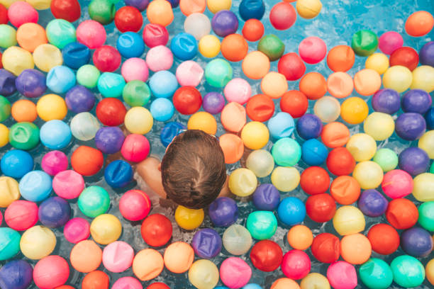 istock Boys playing with balls at the pool in Mexico 1205769927