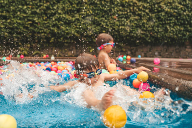 istock Boys playing with balls at the pool in Mexico 1205769950