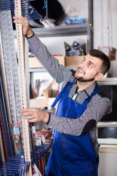 istock Male middle age labour working in PVC shop and smiling 1205770033