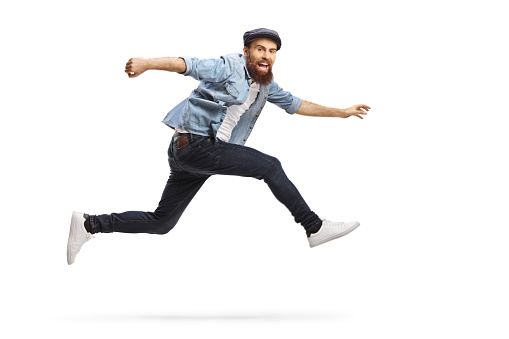 Bearded man in casual clothes jumping isolated on white background
