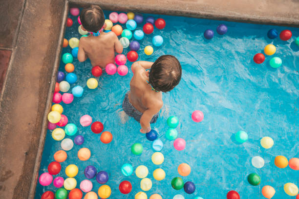 close-up Face boy playing ball, pink and blue balls