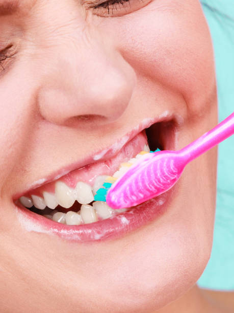 istock Woman brushing cleaning teeth 1205780510