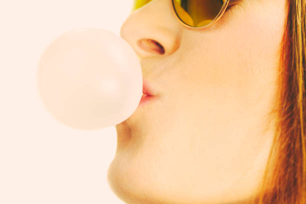 istock Woman doing bubble with chewing gum 1205780665