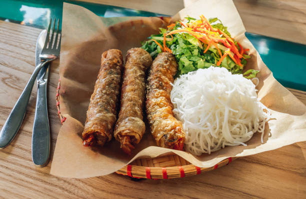 istock Traditional vietnamese fried spring rolls or nems served with salad and noodle. Selective focus 1205782073