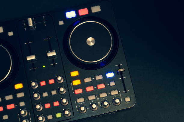 istock Dj sound mixer controller with knobs and sliders. audio mixing deck with turntables at dark with illuminated controls 1205782276